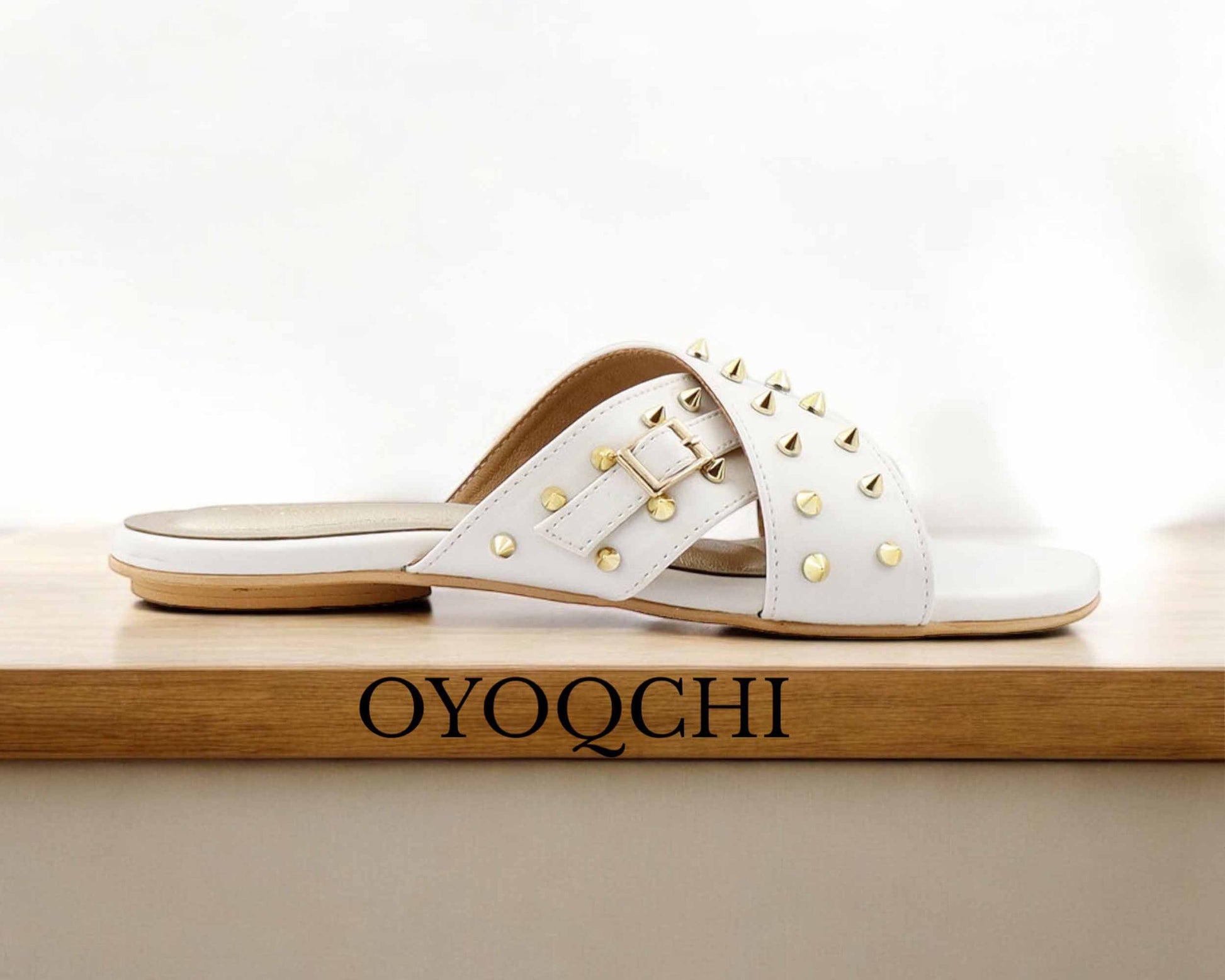 Women's white flat footwear for use in parties and marriages.